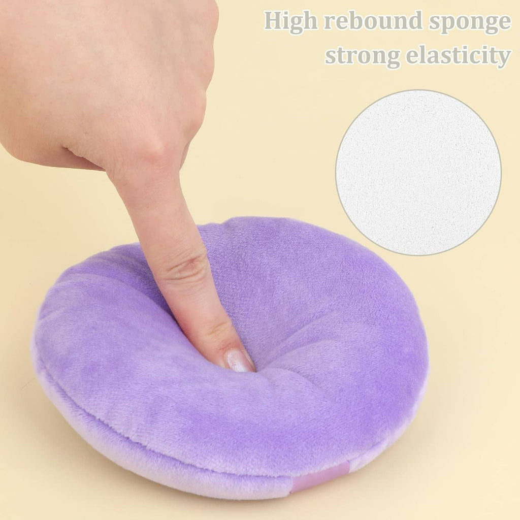 Lavender round velour makeup puff with light-lavender center strap, hand pressing