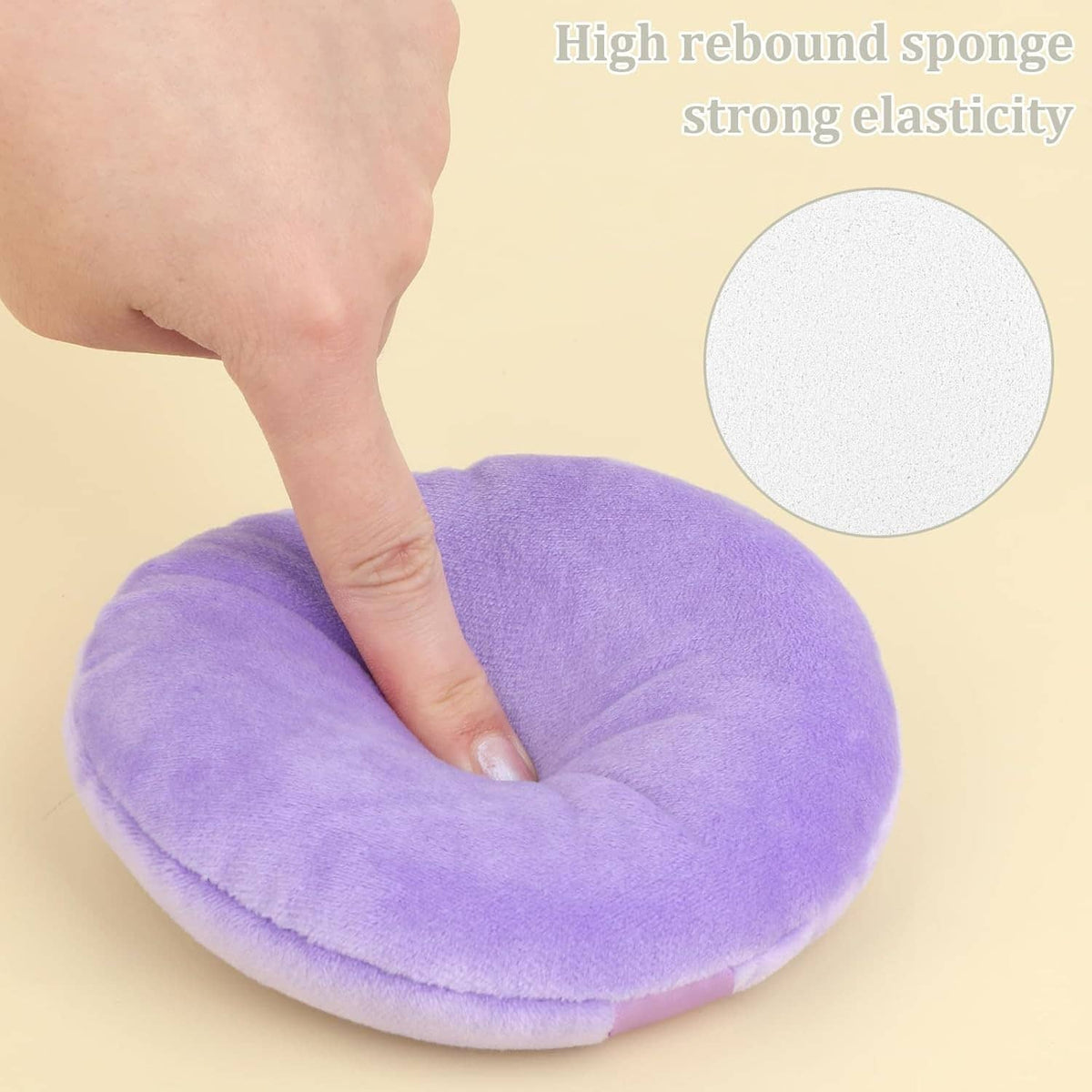 Lavender round velour makeup puff with light-lavender center strap, hand pressing