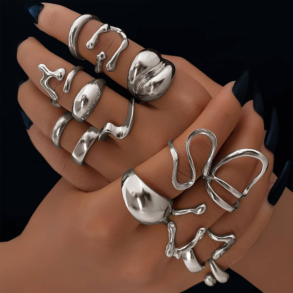 Silver oversized chunky rings on fingers, sculpted domes and openwork cuff accents