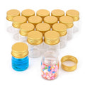 Set of small clear glass sample vials with gold screw caps, some filled with blue liquid