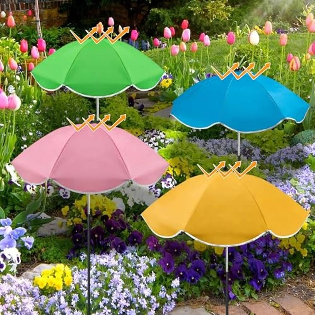 Four outdoor plant umbrellas in bright colors displayed among blooming garden flowers