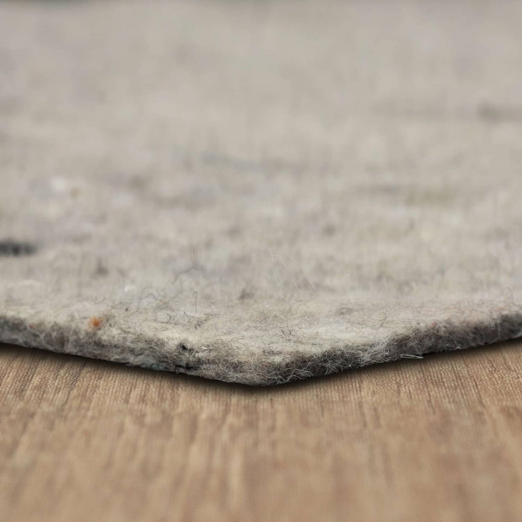Light gray felt rug pad, textured top edge for cushioning under area rugs