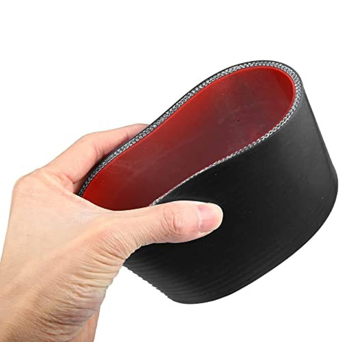 Black silicone reducer hose with red inner lining, held in hand; textured black outer