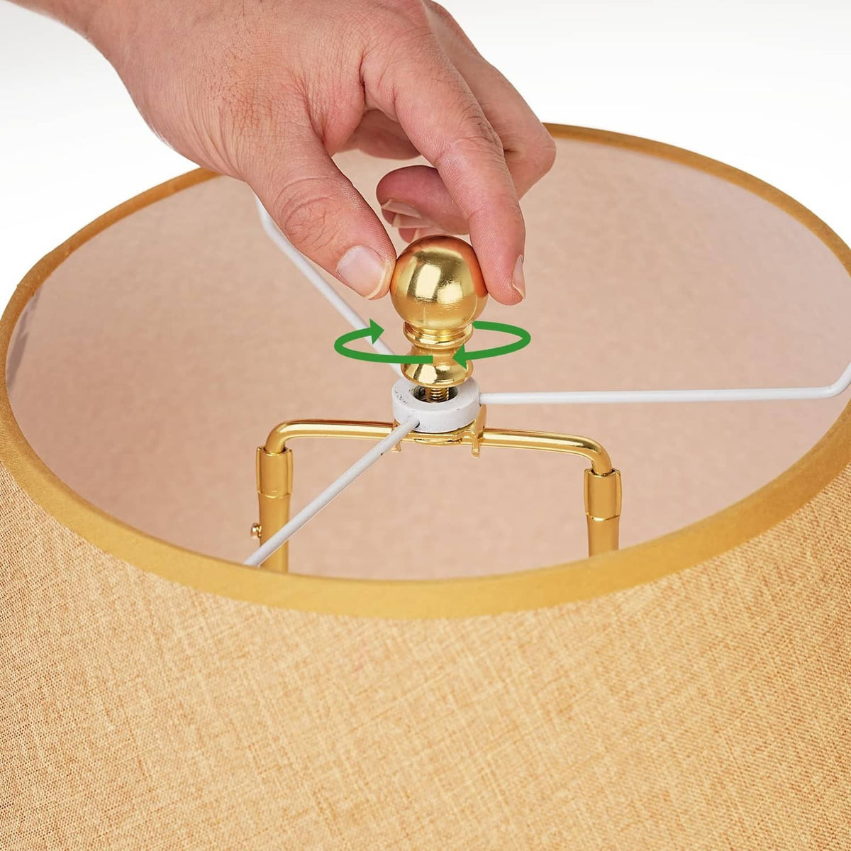 Gold lamp shade finial cap knob with threaded insert, hand placing it