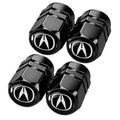 Four black metal tire valve stem caps with Acura logo, faceted hex design
