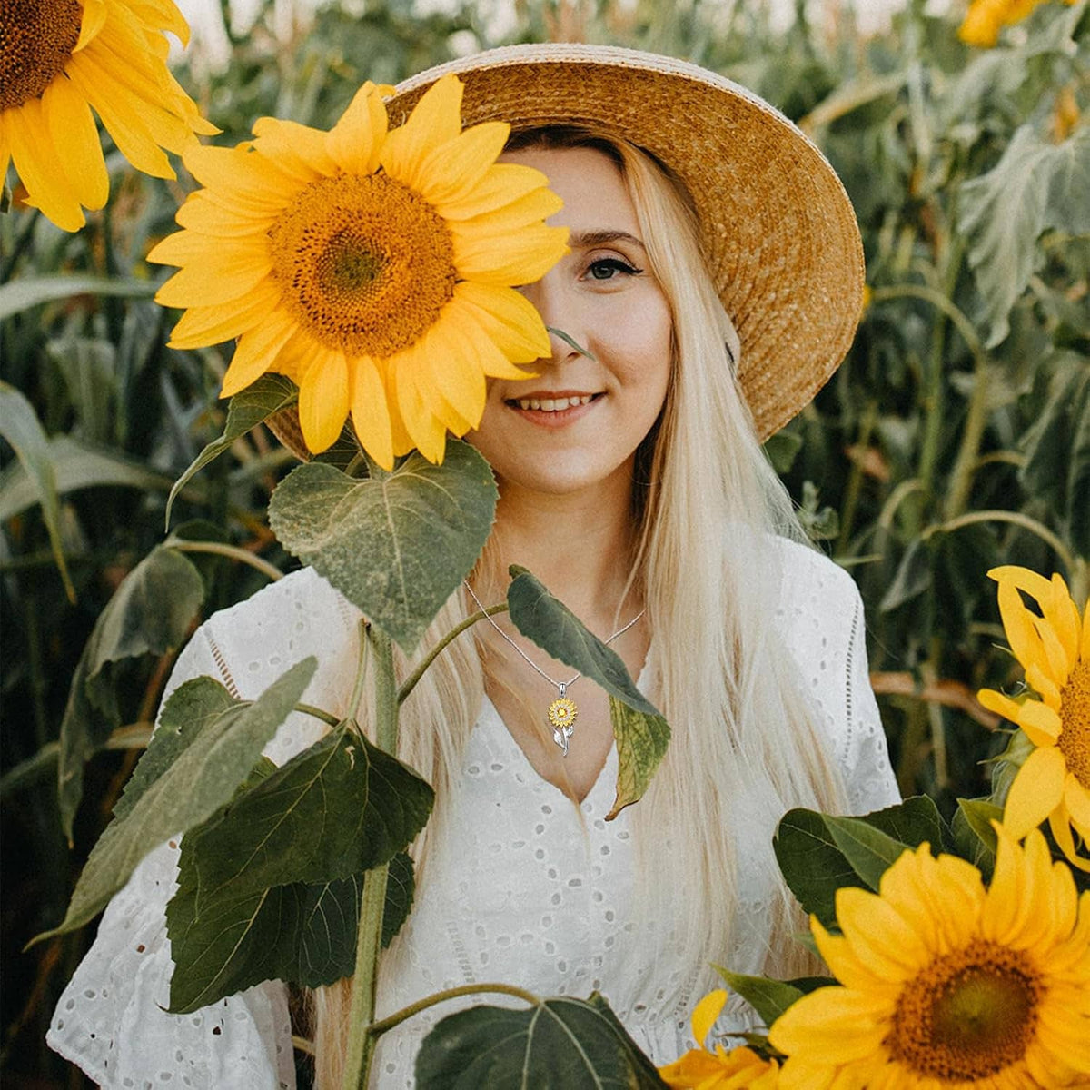 Sunflower pendant necklace with gold petals and silver leaves worn by a woman