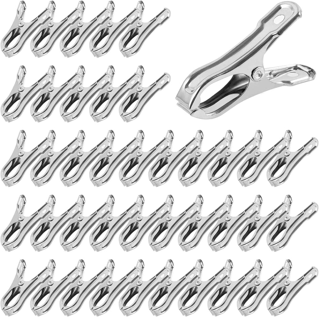 Stainless steel open greenhouse clips, silver spring clamps arranged in rows.