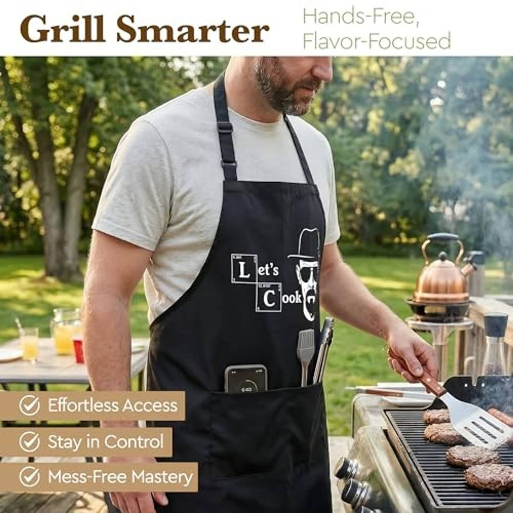 Black cooking apron with “Let’s Cook” graphic, front bib and utility pocket
