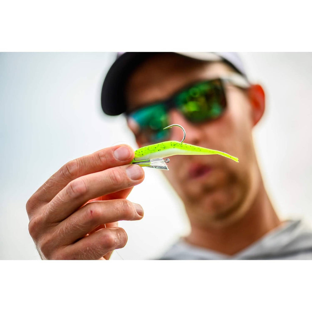 Green chartreuse minnow lure in hand with exposed treble hook