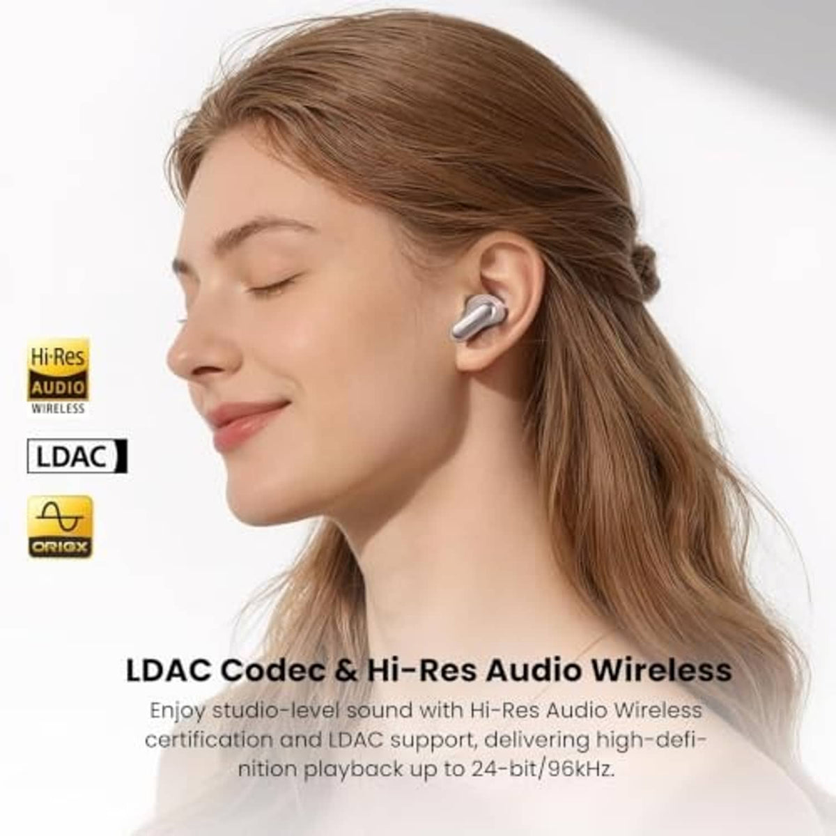 Pink wireless earbuds in a woman’s ear with wireless audio icons