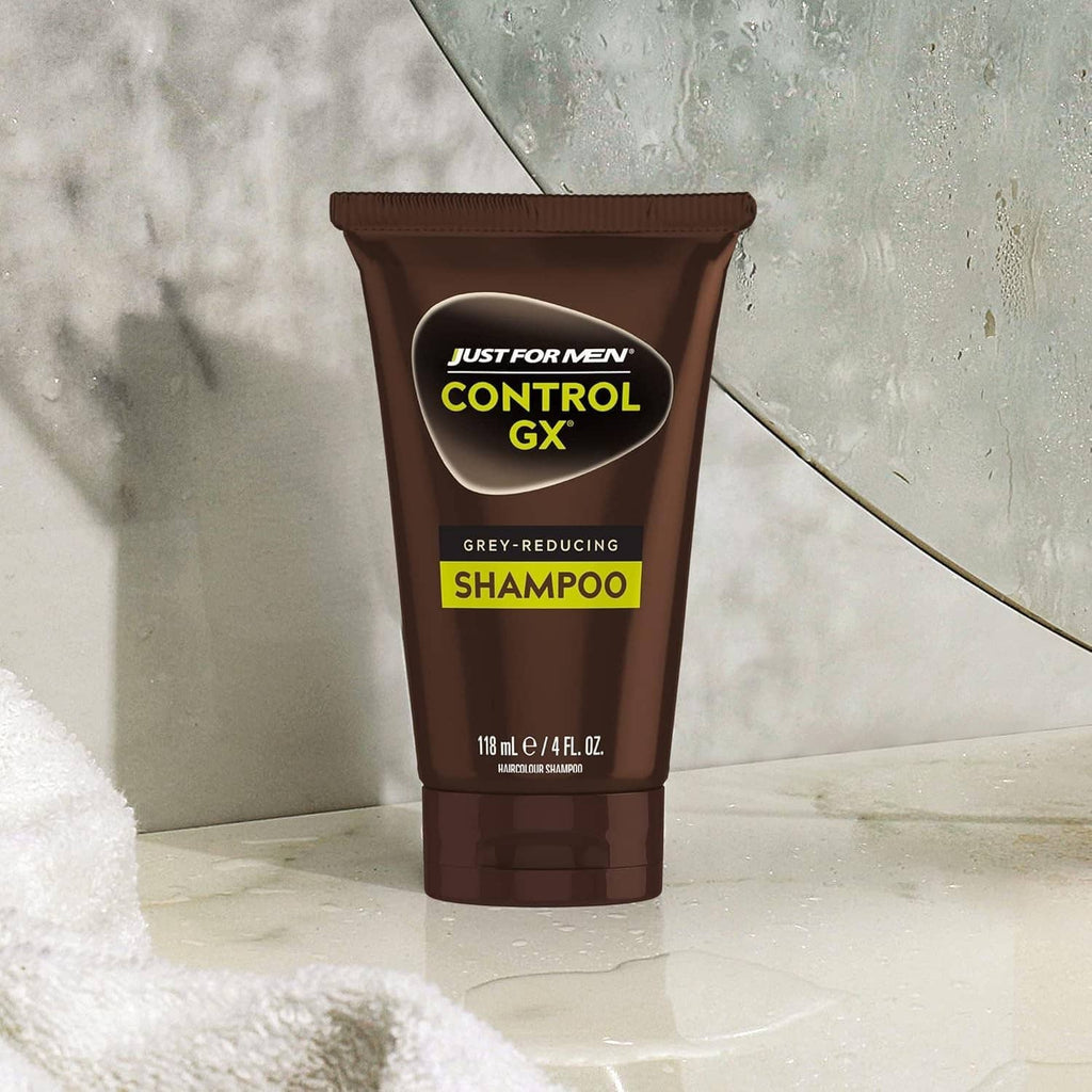 Control GX gray-reducing shampoo tube on bathroom ledge with droplets