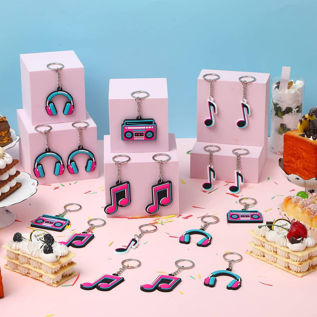 Music-themed keychain set with colorful headphones and music-note charms in boxes