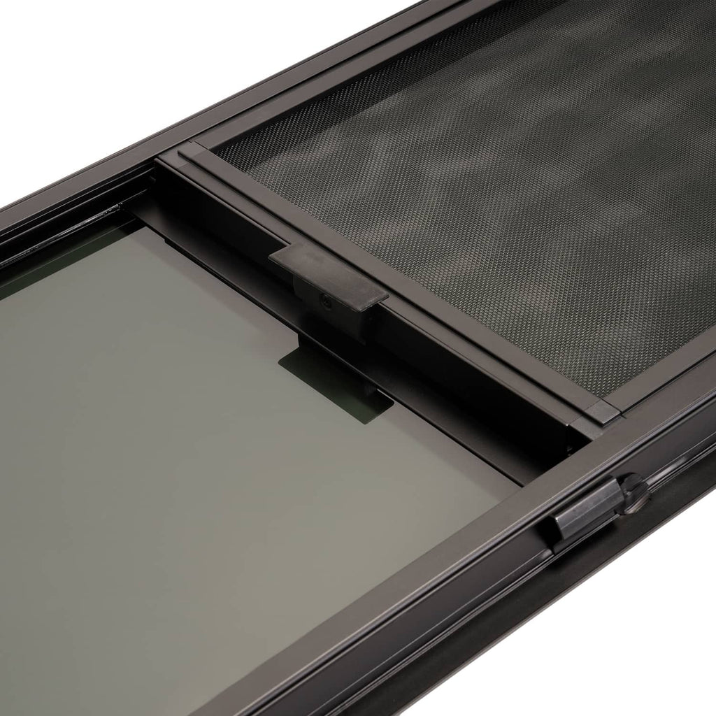Close-up of sliding window track and latch area inside dark frame