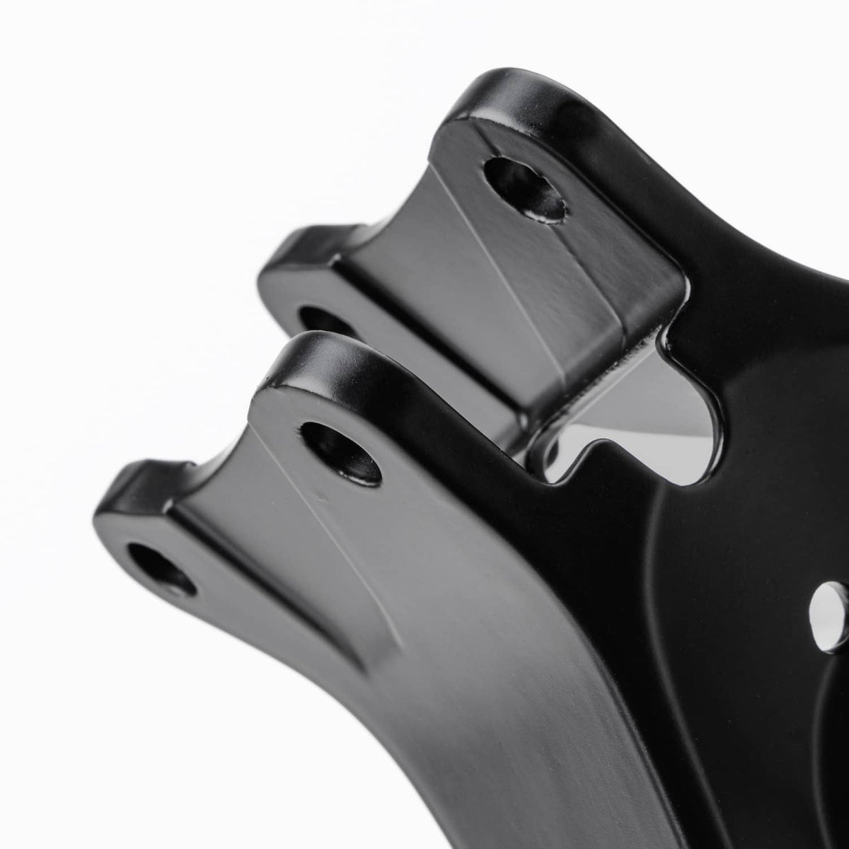 Black mounting bracket tab with two circular holes in close-up