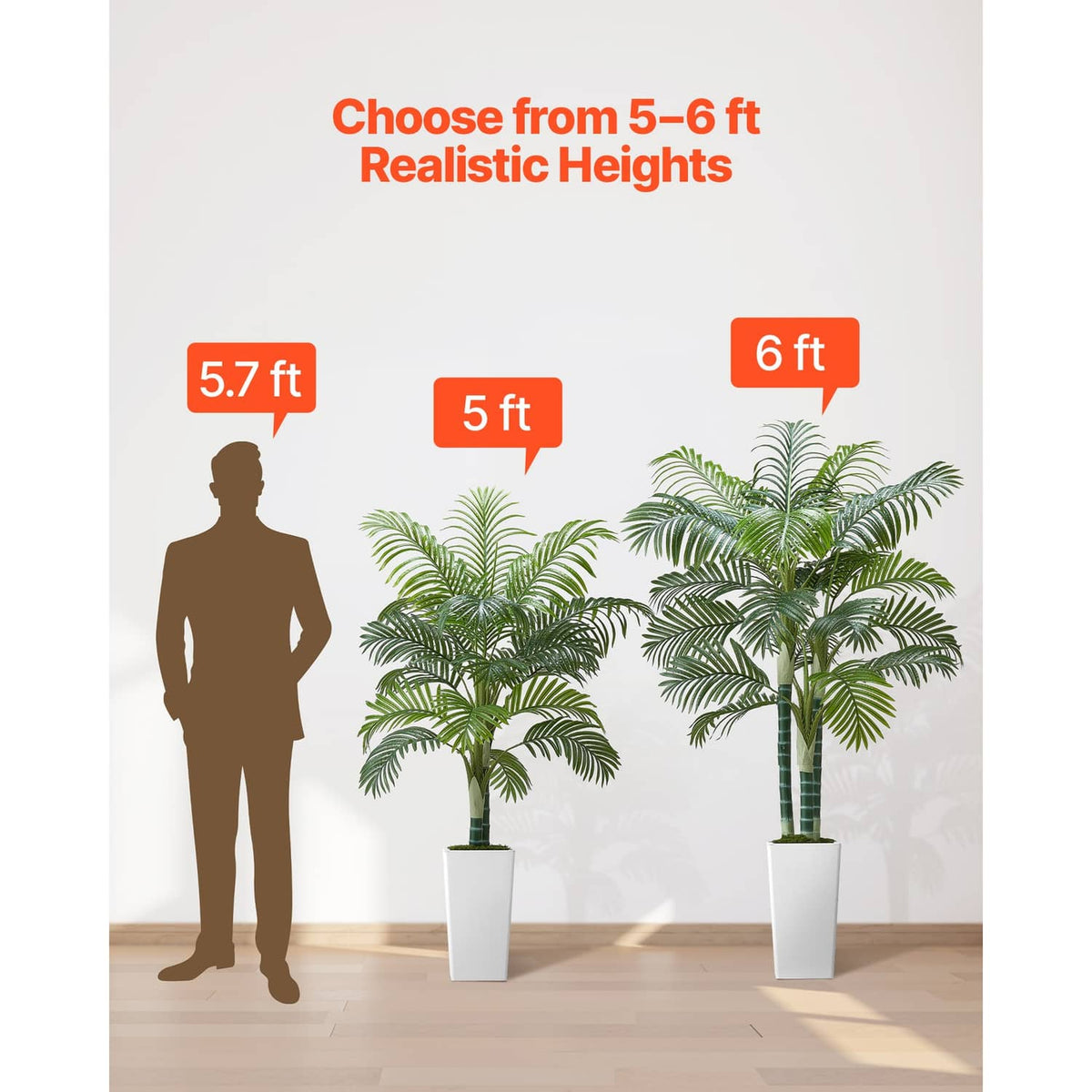 Set of faux areca palm trees in white pots showing different heights