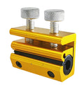 Gold metal cable lubrication tool with two knurled caps and black connector openings.