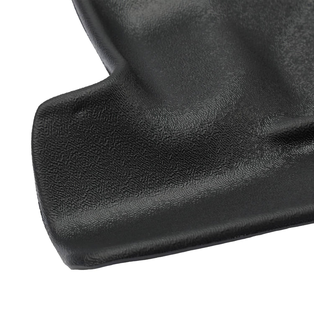 Close-up of black floor mat liner edge with molded border