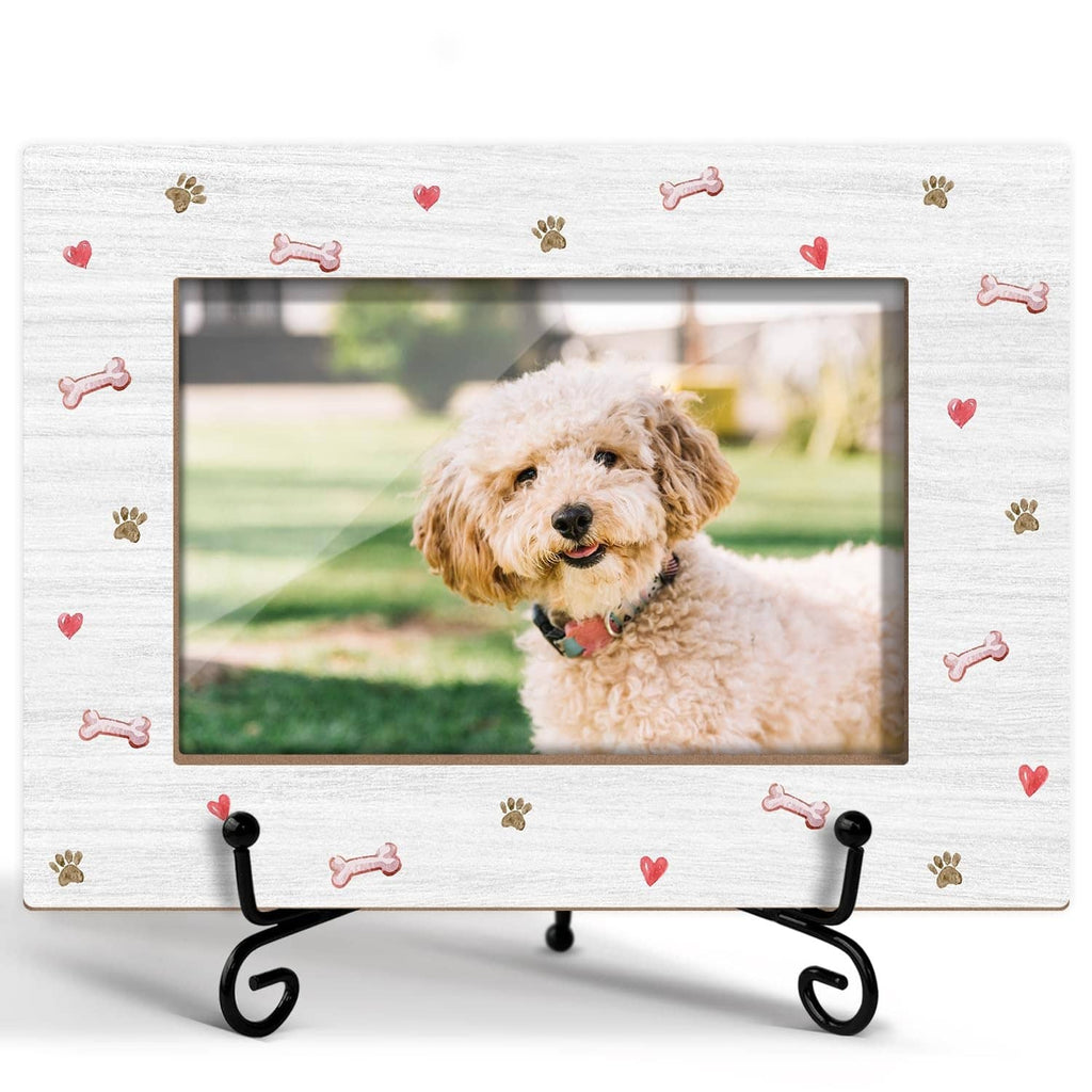 White dog photo frame with multicolor paw prints and bones, on black metal stand.