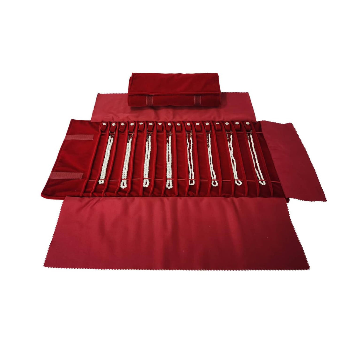 Burgundy jewelry travel roll opened to show lined necklace pockets with bead straps