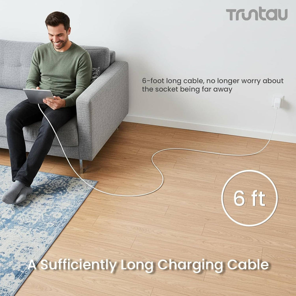 White long USB-C charging cable stretched across a living room floor