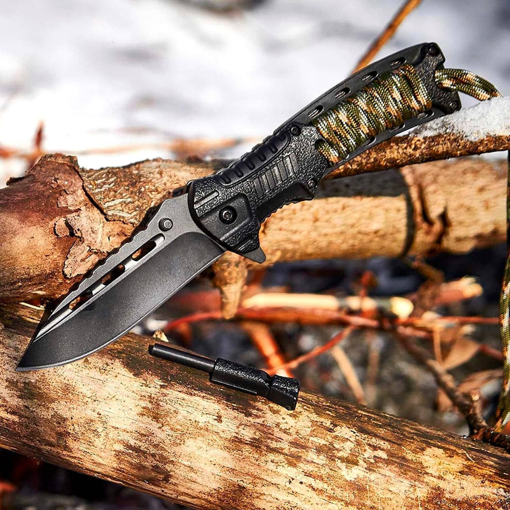 Black folding survival knife with paracord handle and fire-starter rod