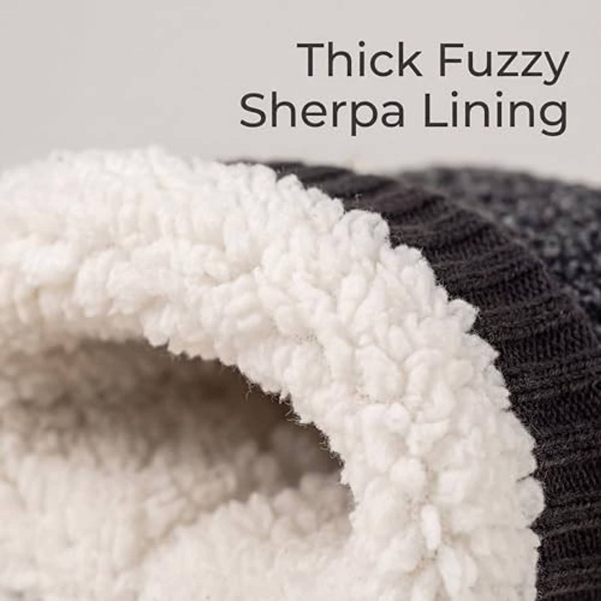 Thick white fleece lining inside grey fuzzy boot slipper with ribbed knit edge
