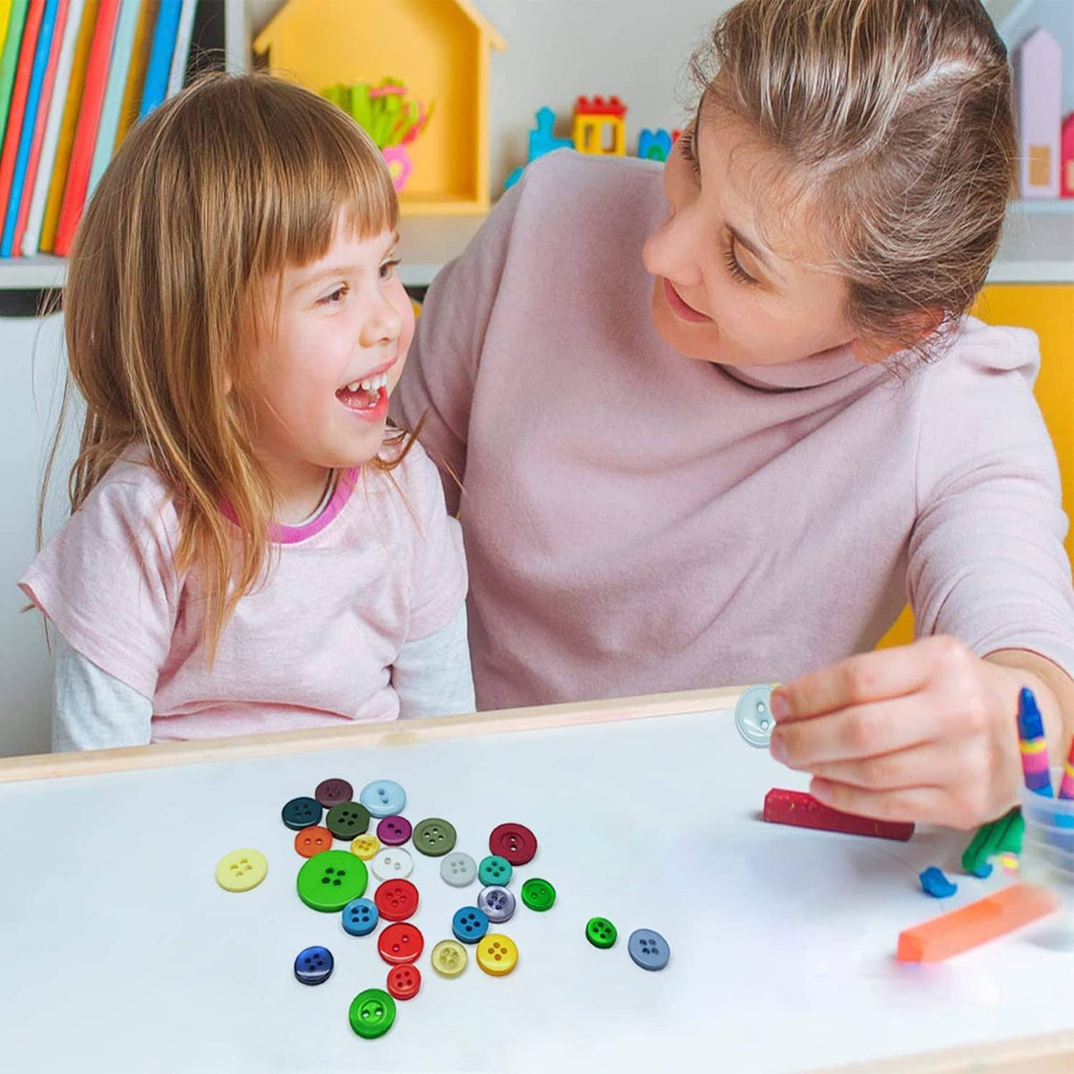 Small round buttons in assorted colors on a table during a kid sewing craft.