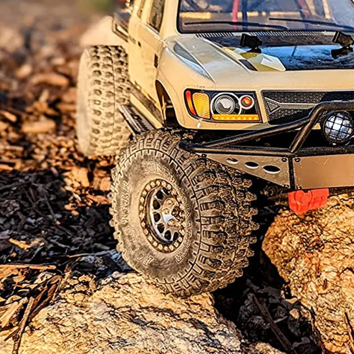 Black crawler tires on an RC truck, mounted on rocky terrain