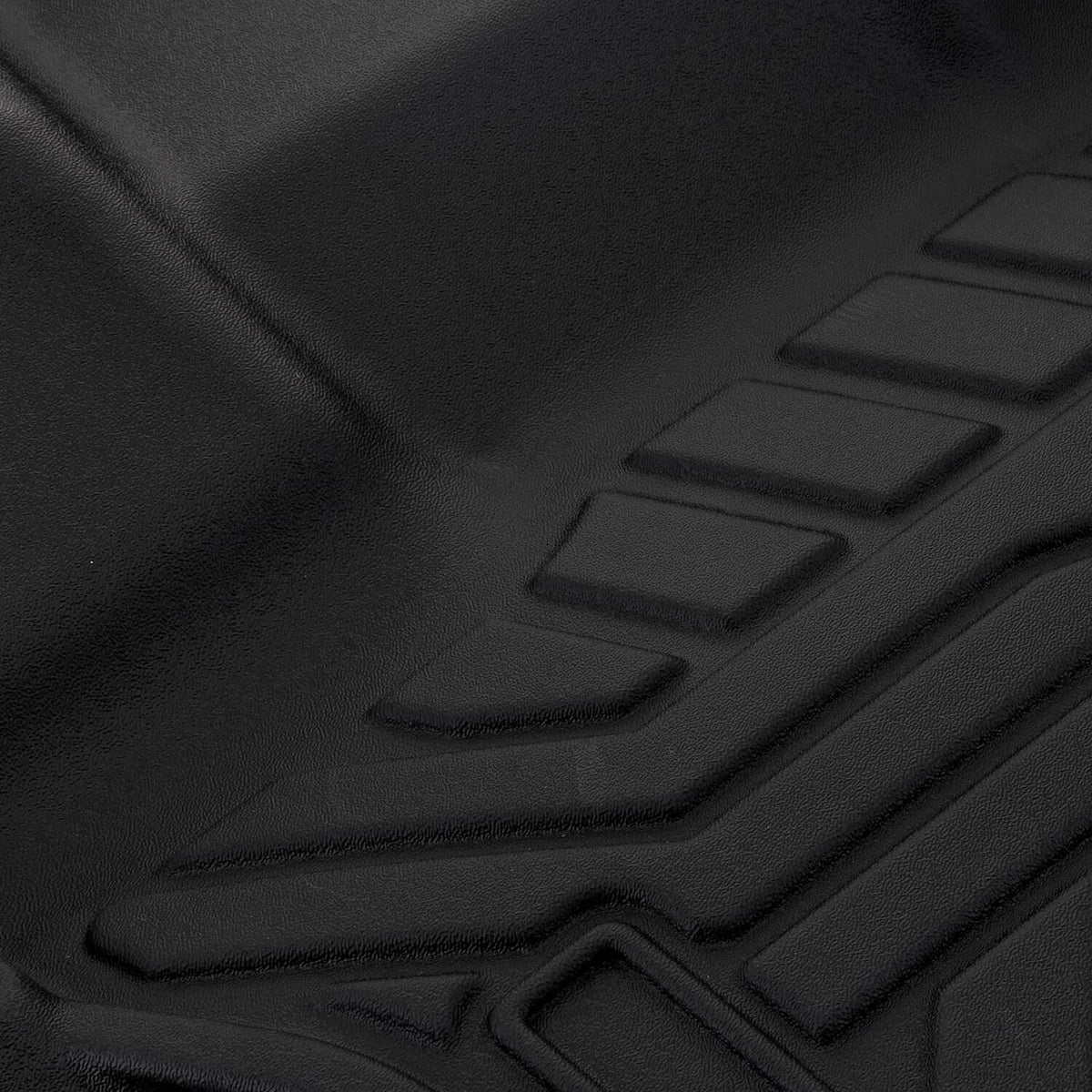 Black waterproof front floor mat with raised channels and molded edge lip
