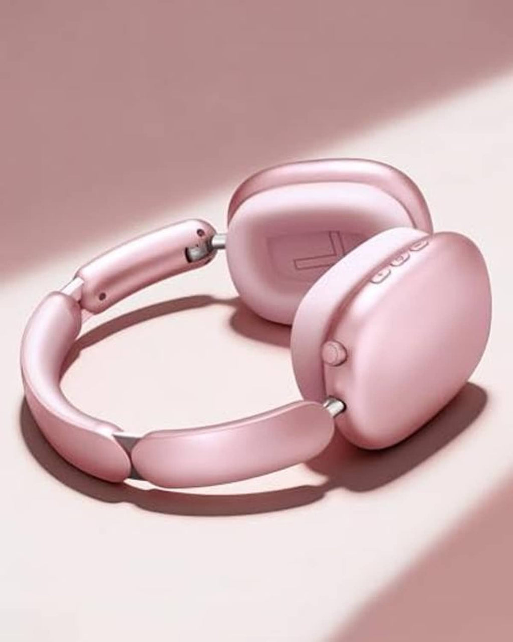 Pink over-ear wireless noise-cancelling headphones with folded earcups and headband