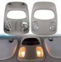 Grey overhead map light console housing with two clear lens lamps and center switch panel