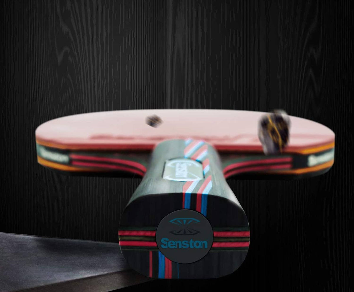 Table tennis paddle with pink rubber face and dark red-black handle