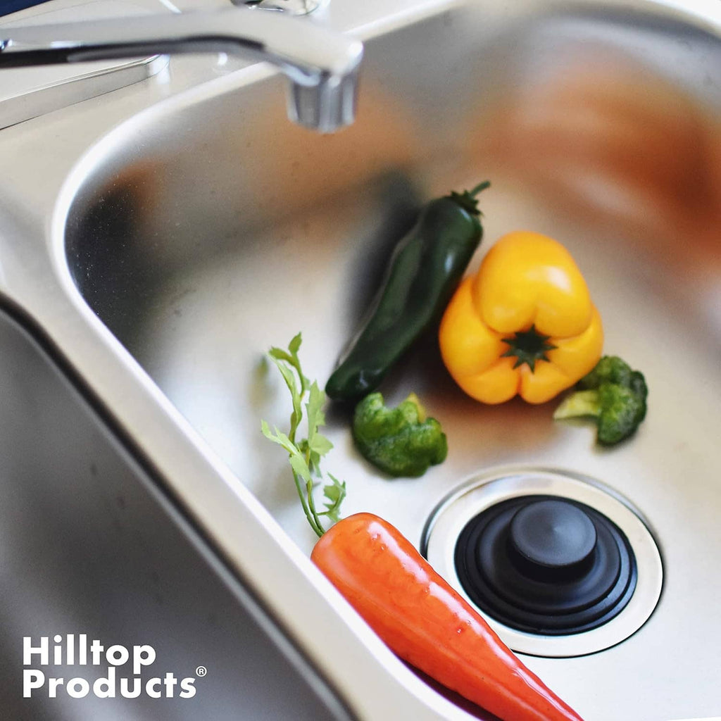 Black garbage disposal sink stopper plug fitted in kitchen drain opening
