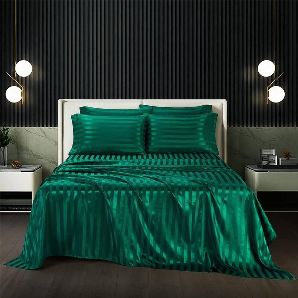 Teal green striped satin sheet set on bed with matching pillowcases and duvet cover