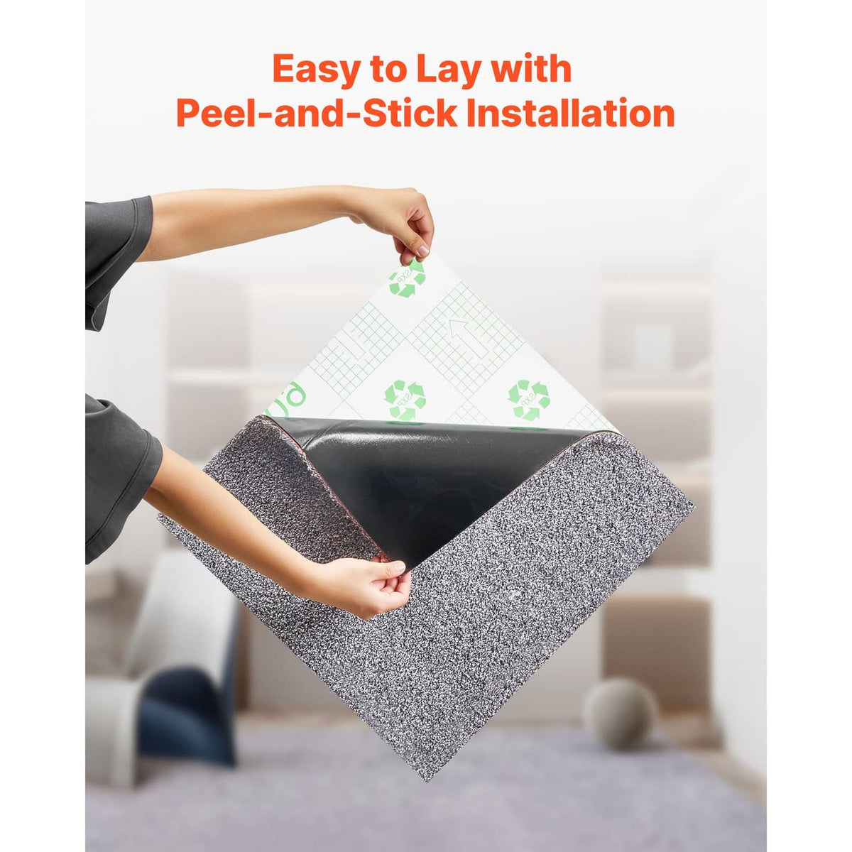 Gray speckled carpet tile being placed with hands for peel-and-stick installation