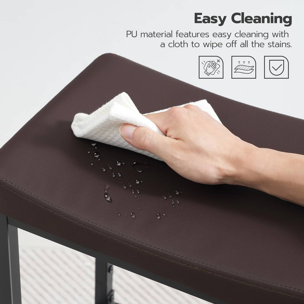 Dark brown bar stool seat with water droplets and cloth wiping, black frame visible.