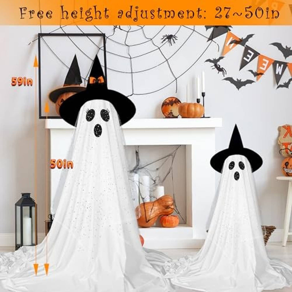 Two standing ghost decorations with black hats and dotted faces, white sheer fabric with flowing drape.