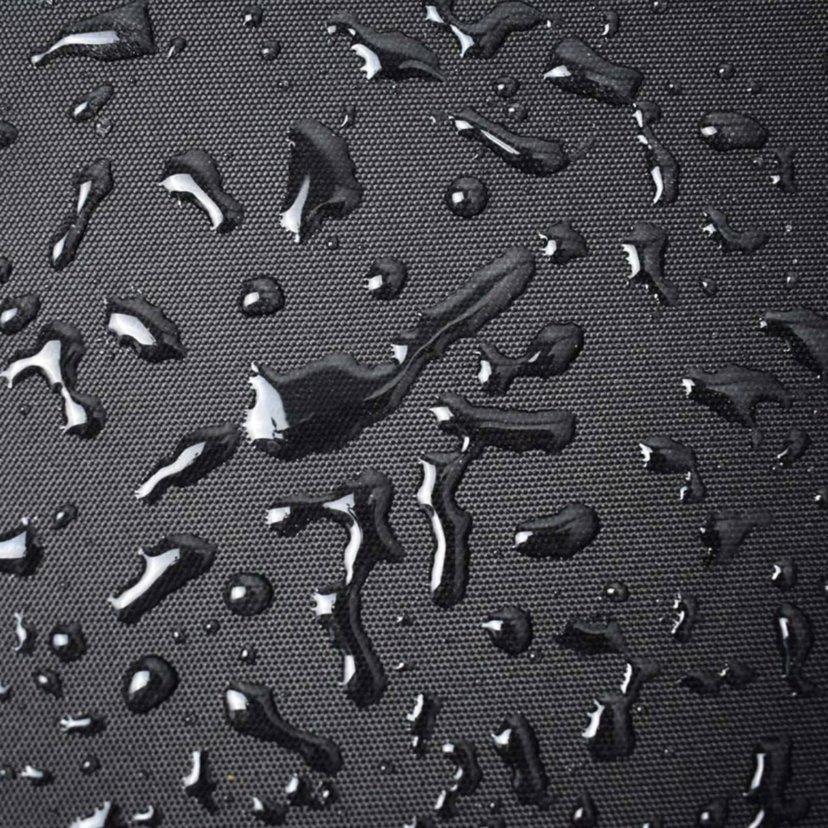 Water-repellent black grill cover fabric with raised texture and visible water droplets