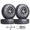 Pair of black beadlock wheels with chunky tread tires and brass-color center plates