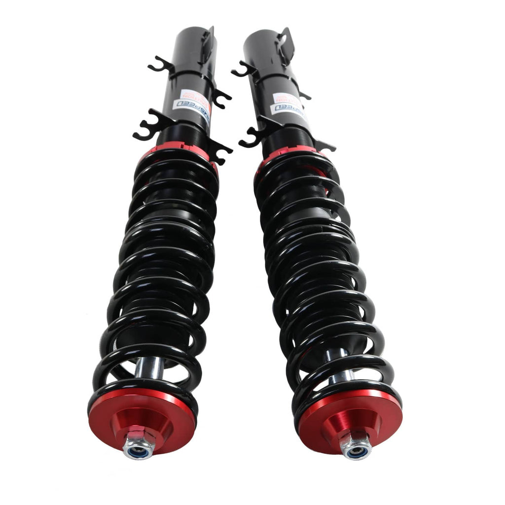 Close-up of two coilovers with black springs and red adjustment bases