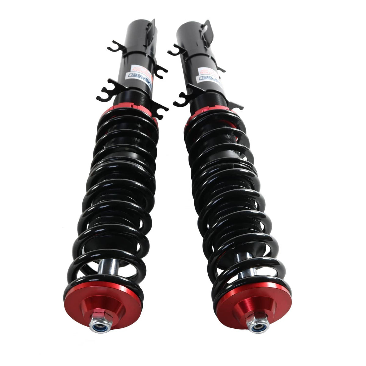 Close-up of two coilovers with black springs and red adjustment bases
