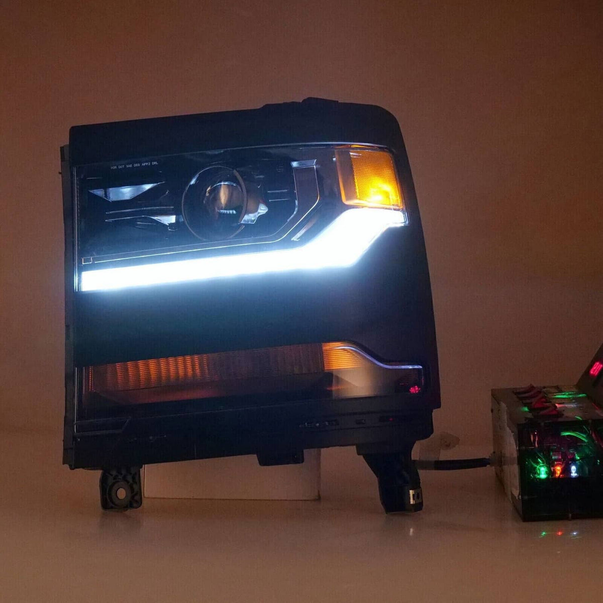 Black HID xenon headlight with white beam and amber DRL strip