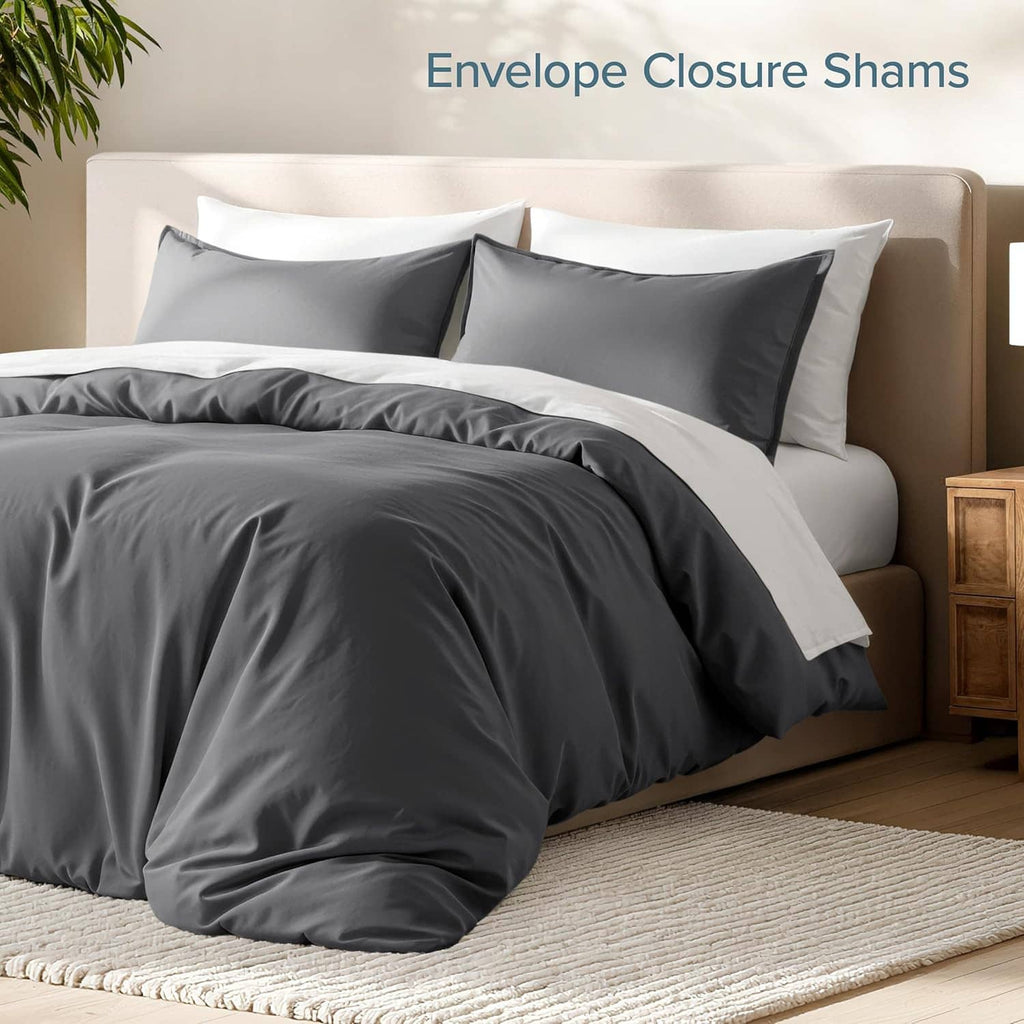 Dark gray duvet cover set with envelope-closure pillow shams, neatly layered.