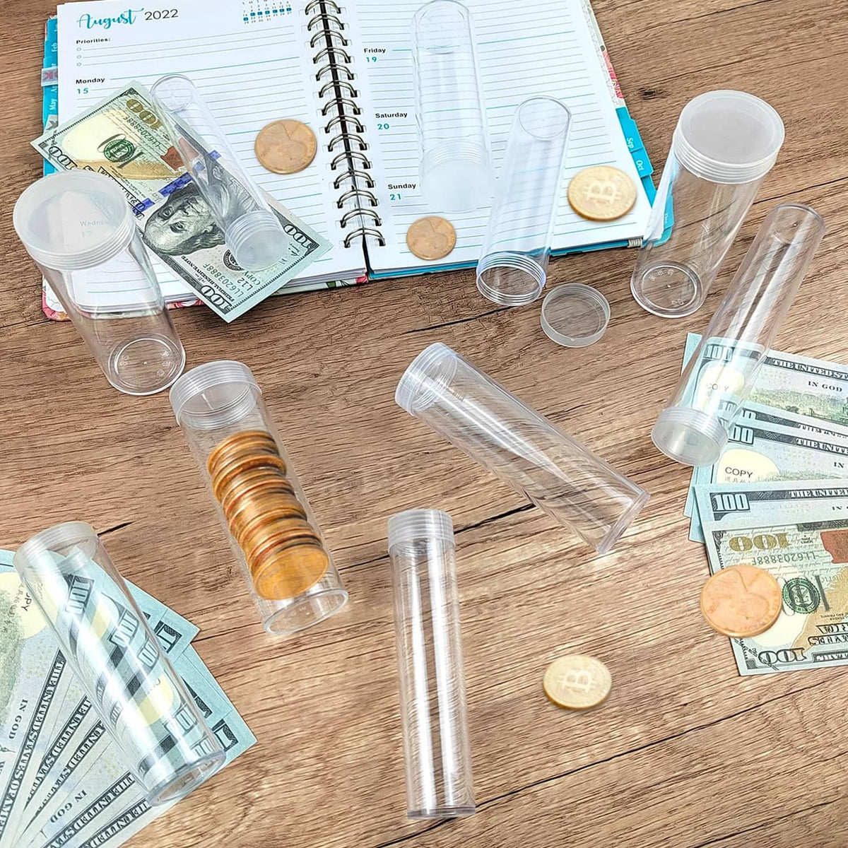 Clear plastic coin tubes with white lids on a tabletop