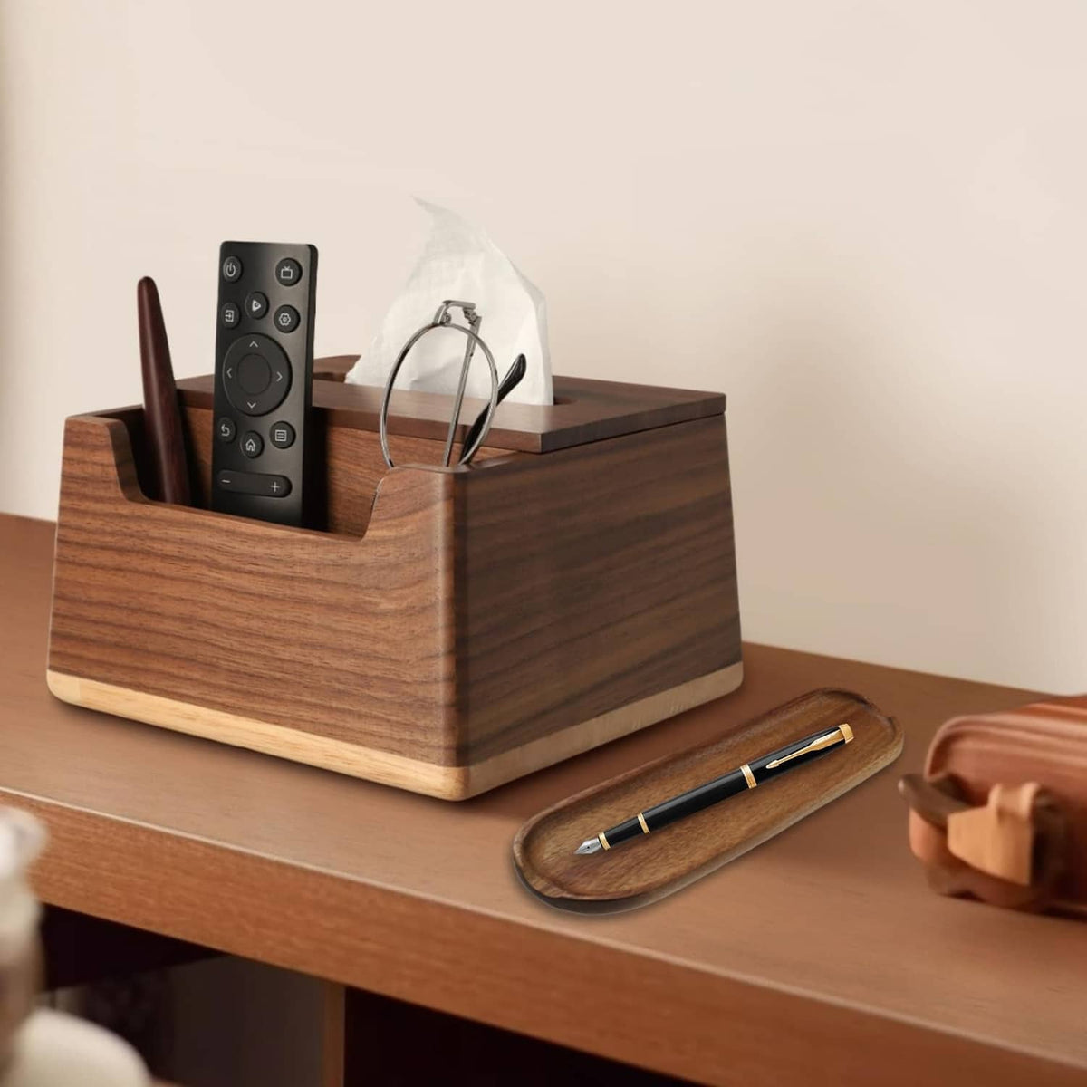 Wood pen tray organizer holding pens, with remote and glasses on desk