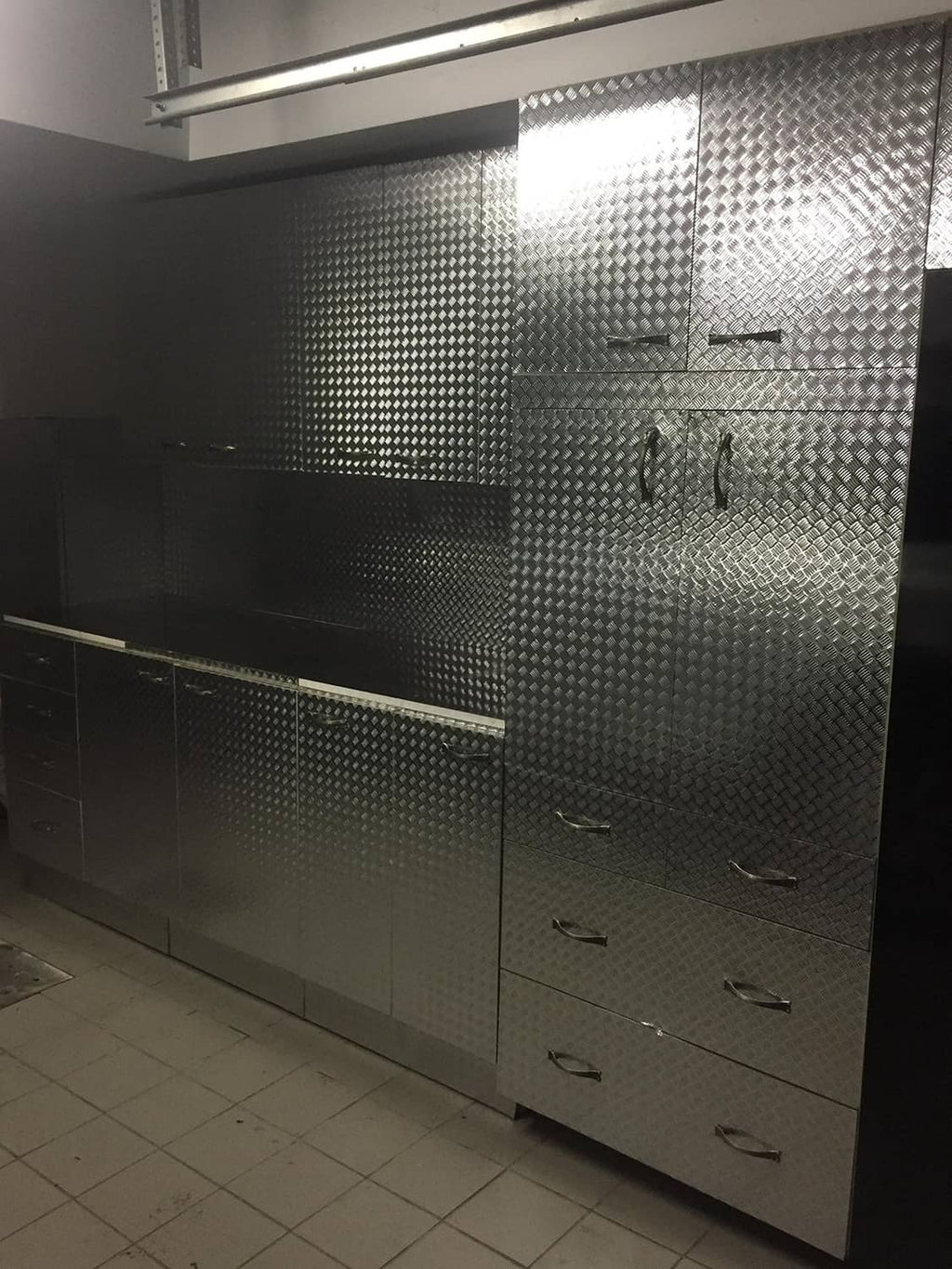 Diamond-plate metallic chrome vinyl wrap wall panels with drawers and handles