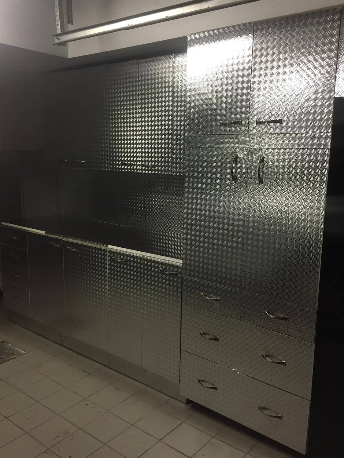 Diamond-plate metallic chrome vinyl wrap wall panels with drawers and handles