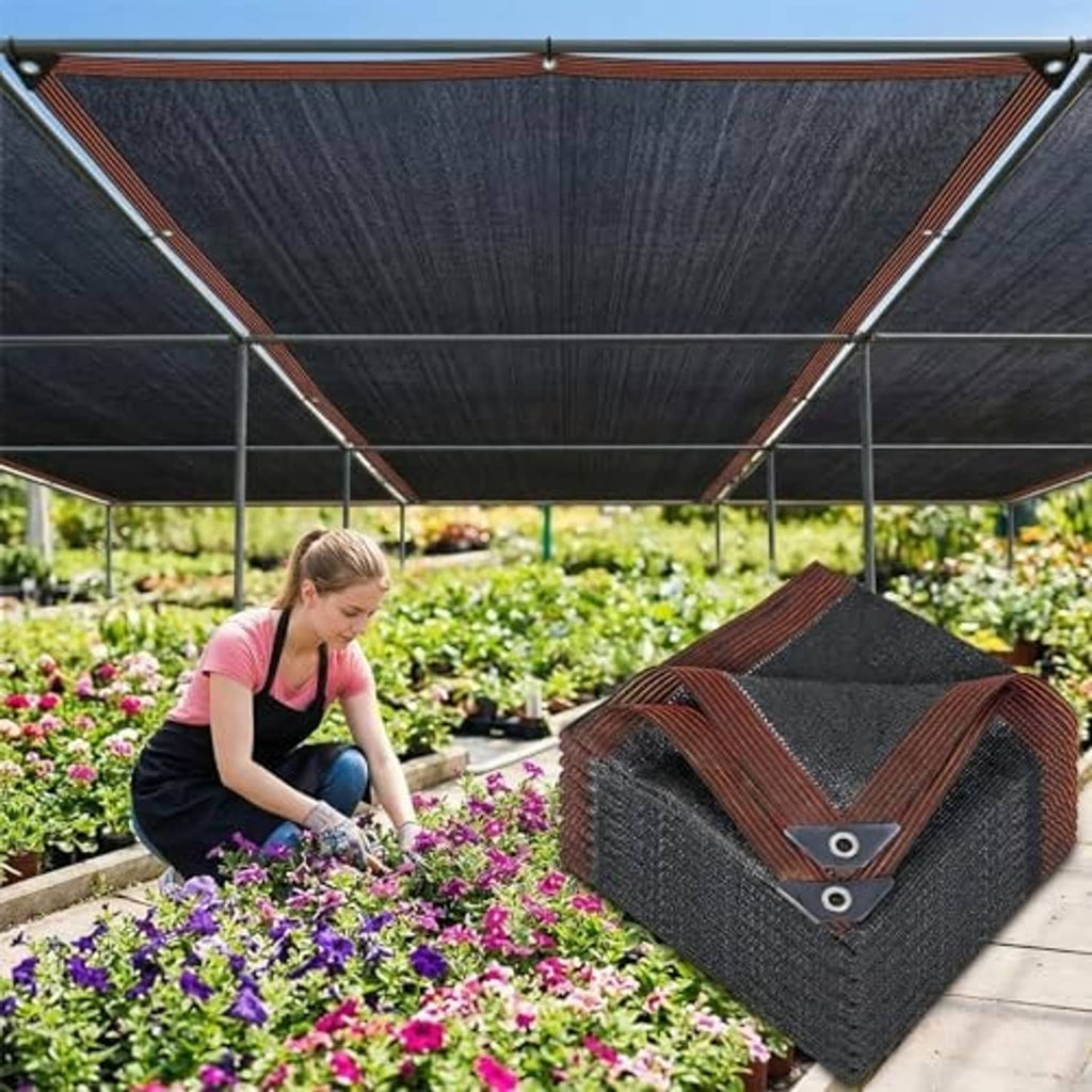 Black shade cloth canopy with brown trim, showing grommets and tied corners