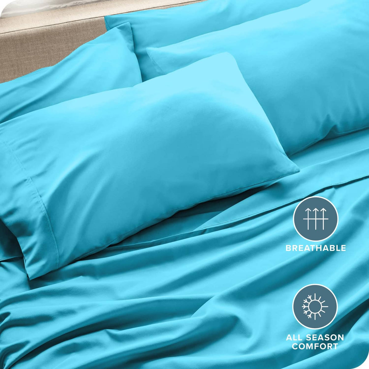 Turquoise pillowcases on a bed with smooth surface and coordinating pillow shams