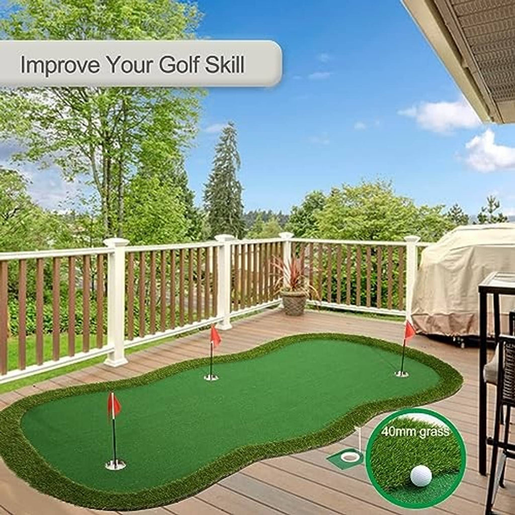 Green putting green practice mat with pin flags and ball near a deck railing